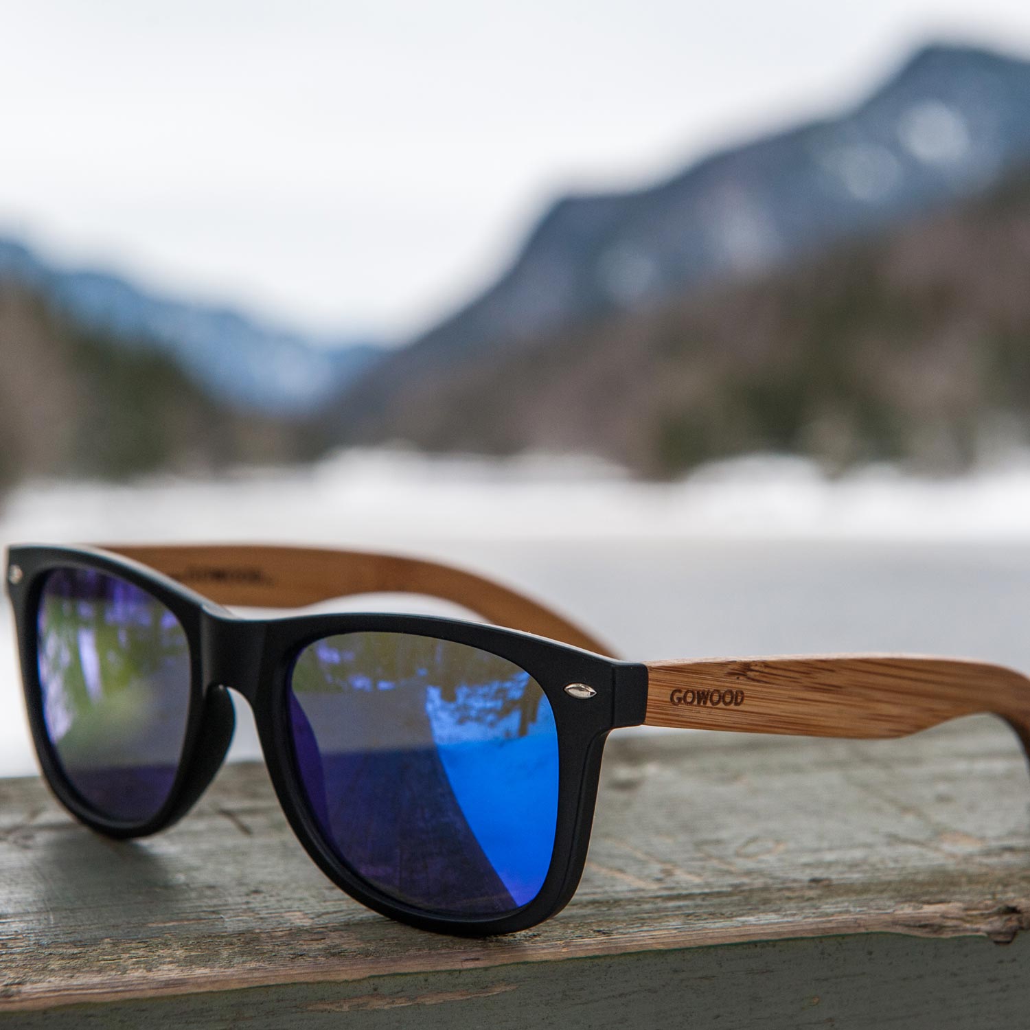 Bamboo wood wayfarer sunglasses blue lenses outdoors