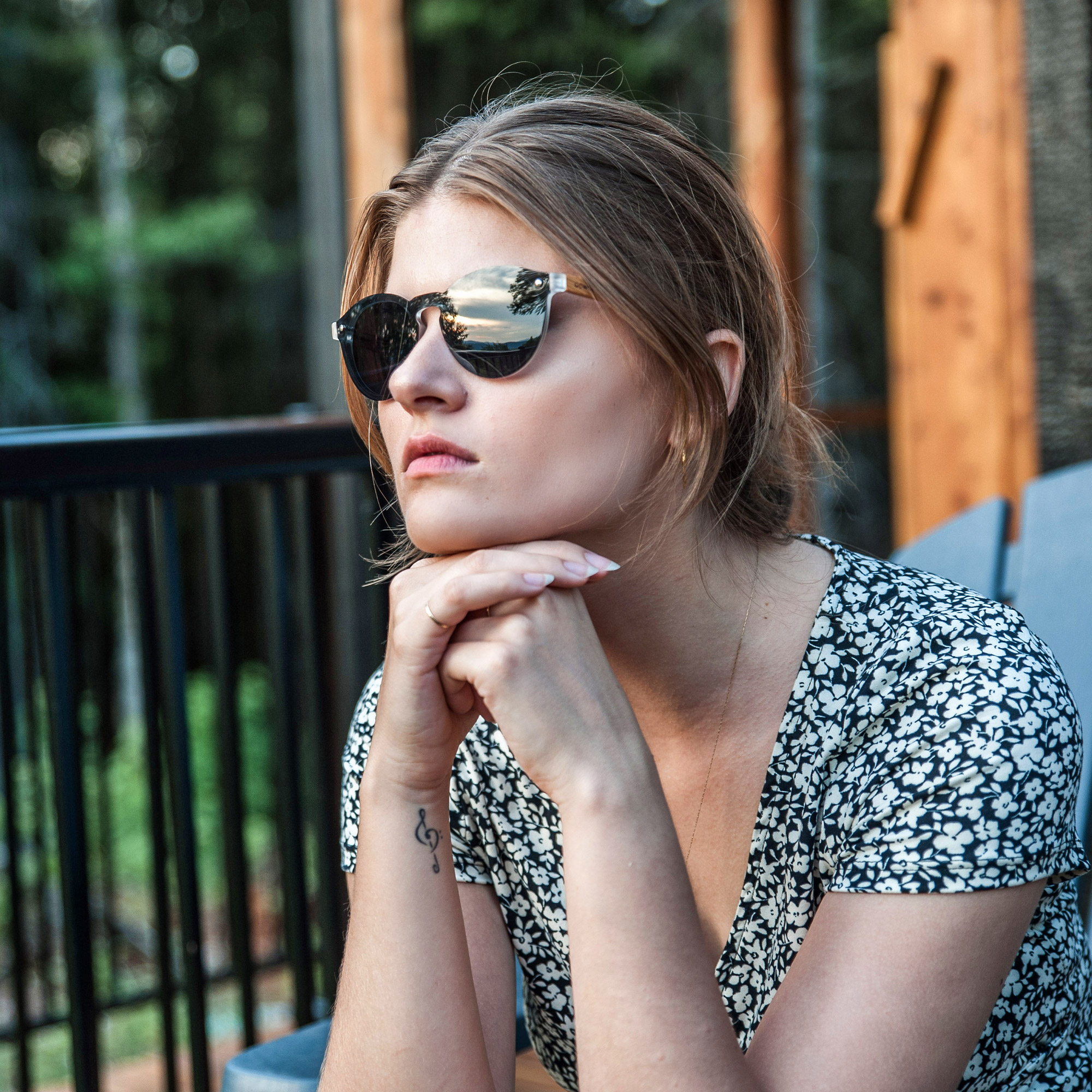Round walnut wood sunglasses with black polarized one piece lens on women