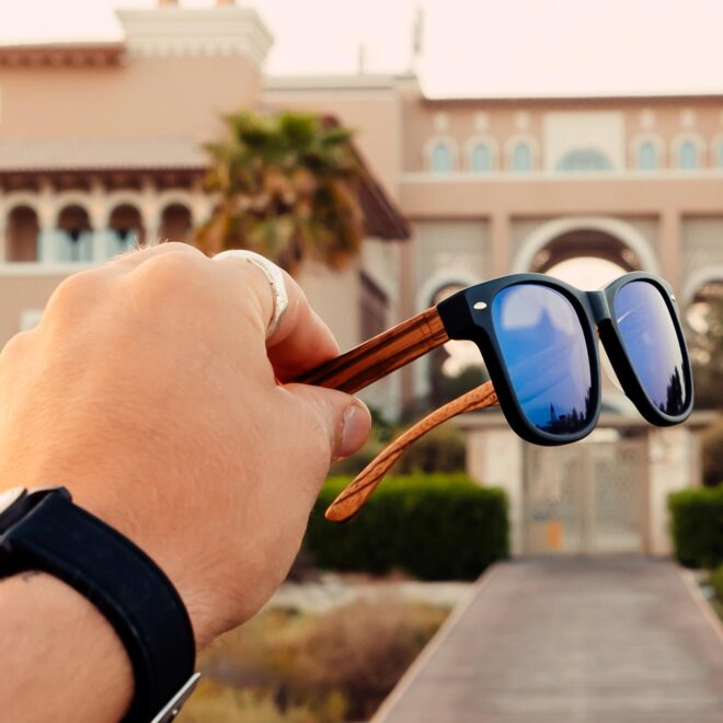 Zebra wood wayfarer sunglasses blue lenses outdoors