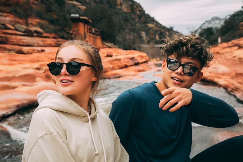 couple wearing wooden sunglasses, in the holiday season