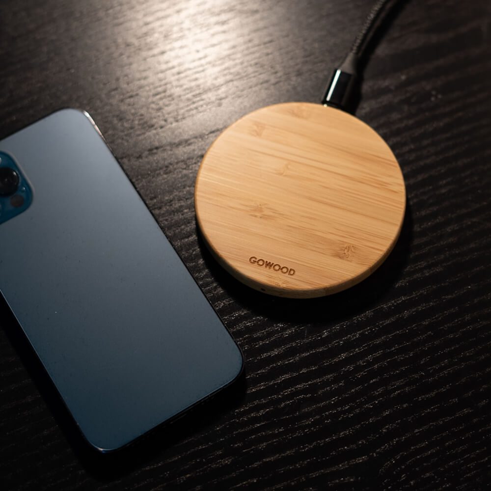 GOWOOD Iphone case sitting next to a wooden wireless charger on a table
