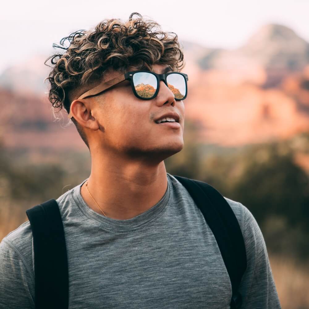 adventurer young man wearing wooden sunglasses from Gowood