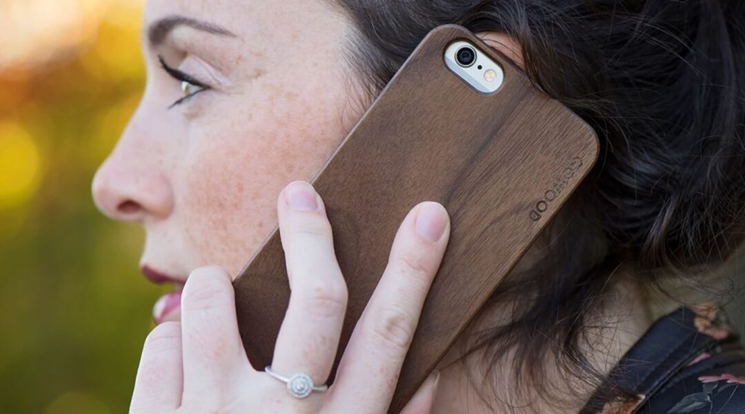 Young lady conversing on iPhone protected with a stylish iPhone wooden case